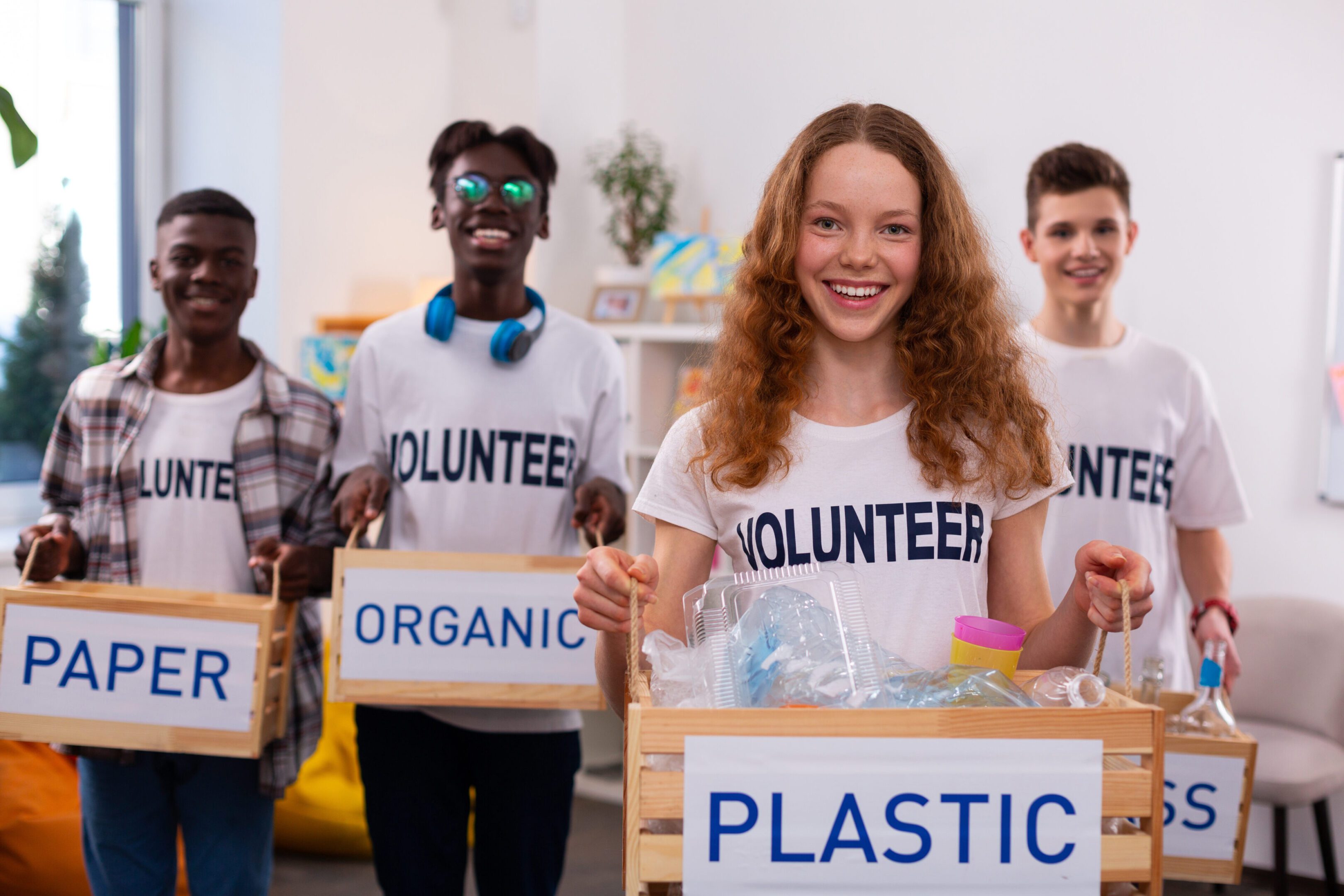 Volunteers sorting recyclable materials into boxes.